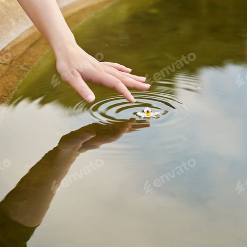 Preview: Creating water ripples. Cropped shot of a finger touching water to form ripples.