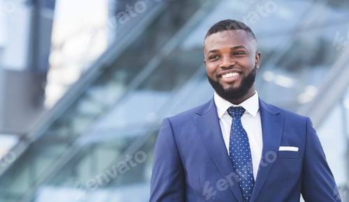Preview: Happy African Entrepreneur Standing In Urban Area In City