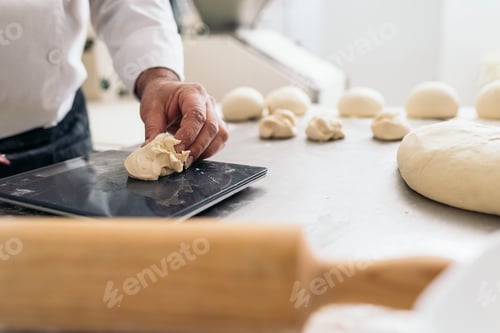 Preview: Baker kneading dough in a bakery.