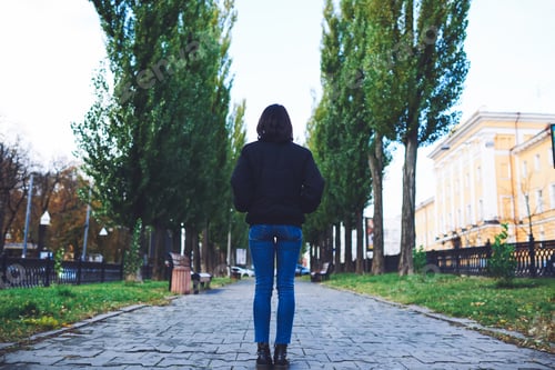 Preview: Woman standing on walking area in city