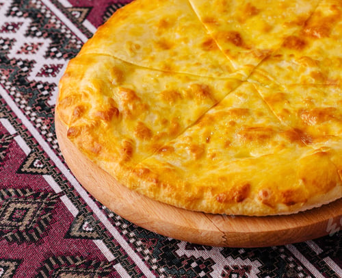 Preview: Traditional georgian cheese bread khachapuri on wooden board