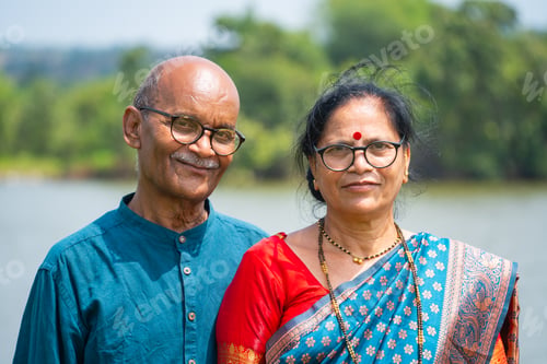 Preview: Happy Indian senior couple near river