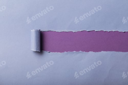 Preview: torn blue paper with rolled edge on violet background