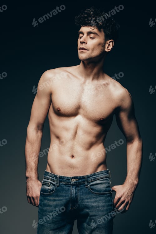 Preview: sexy shirtless muscular man in jeans posing isolated on dark grey