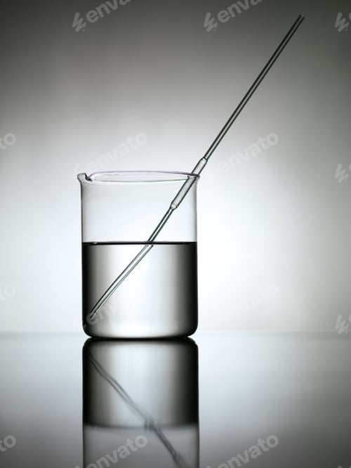Beaker With Liquid and Stir Rod on Table