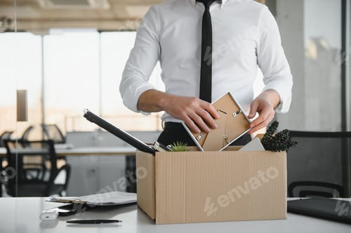 Preview: Close-up Of A Businessperson Carrying Cardboard Box During Office Meeting