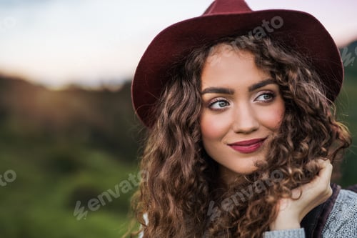 Preview: Close-up portrait of young woman traveller standing in nature