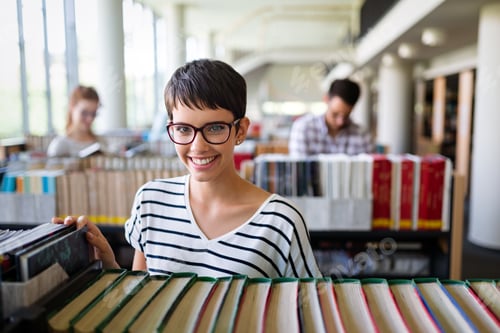 Preview: Happy group of success students studying and working together in a college library