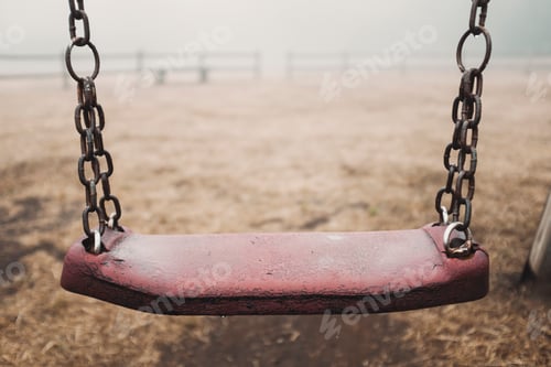 Preview: Scary empty swing at the park with fog in backgroind. Creepy scenic place. Sadness and depression