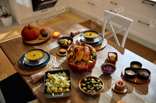 Preview: Thanksgiving turkey and side dishes served on dining table.