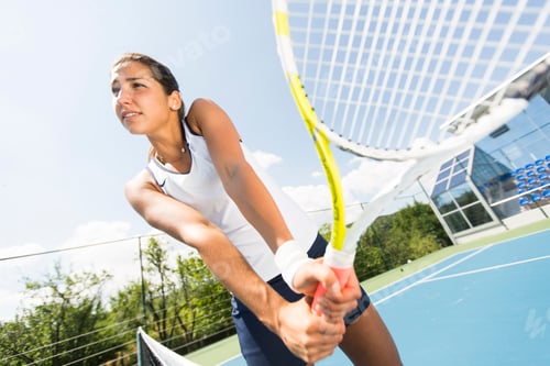 Preview: Young woman playing tennis