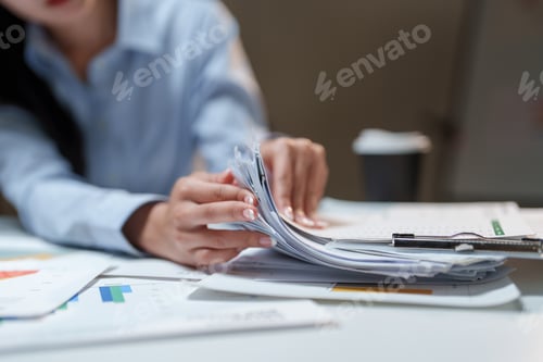 Preview: Woman organizing financial documents and business reports