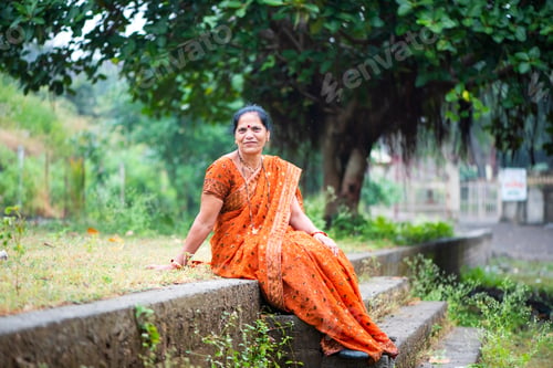 Preview: Happy Indian woman in traditional clothes at outdoor.