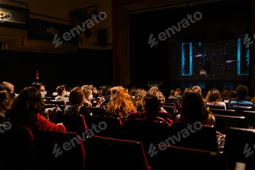 Preview: people with a mask watching a show in a theater maintaining sanitary measures