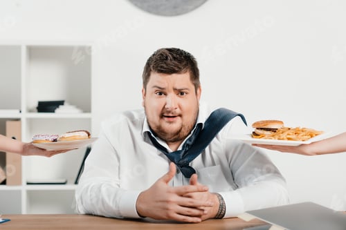 Preview: overweight businessman choosing junk food for lunch