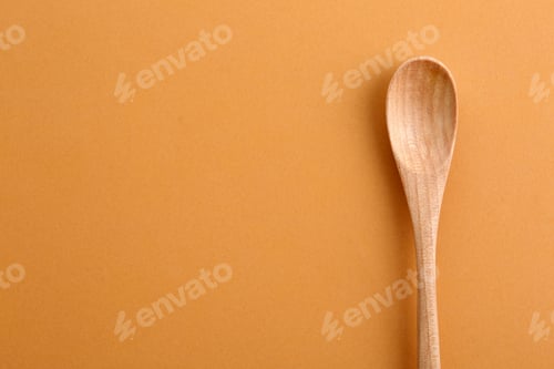 Preview: Clean wooden spoon and space for text on color background, top view