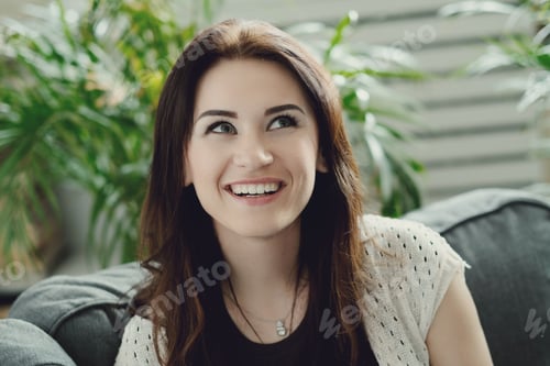 Smiling Woman Relaxing on a Comfortable Couch
