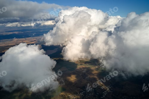 Preview: Aerial view at high altitude of earth covered with puffy cumulus clouds forming before rainstorm