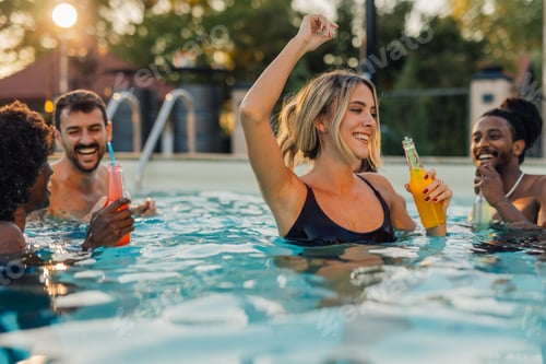 Preview: Friends enjoying drinks and dancing in swimming pool
