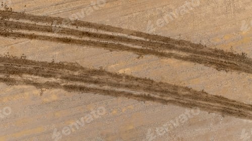 Preview: Aerial top view tire track on dirt sand mud, Texture of wet mud road with puddle