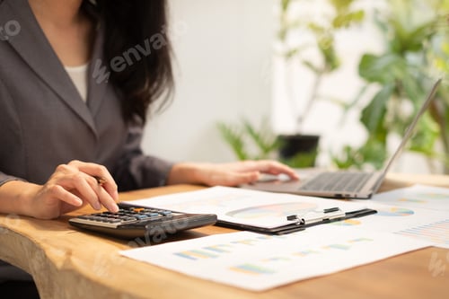 Preview: Asian businesswomen calculate financial graphs showing results about their investments and planning