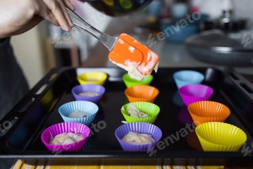 Preview: making of delicious cupcake in kitchen. Muffin tin with liner, ingredients, and utensils are seen. A