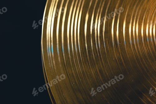 Vista previa: Drum cymbal close-up on a dark background, top view.