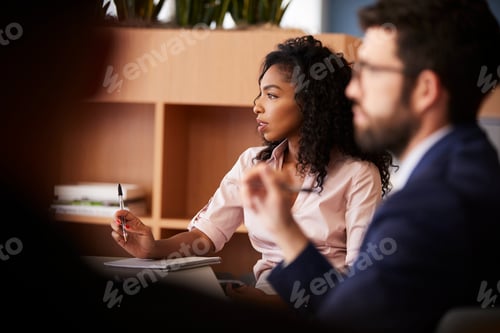 Preview: Businesswoman Making Notes Sitting At Table Meeting With Colleagues In Modern Office