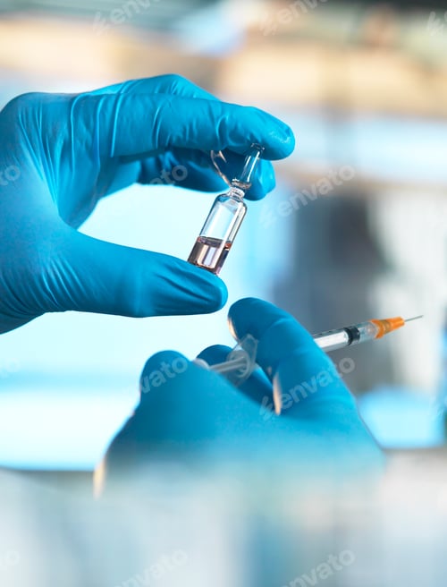 Preview: Scientist holding a vial containing a liquid in the laboratory