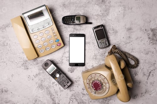 Preview: An old telephone with rotary dial, a landline, an obsoleted cellphone and smartphone