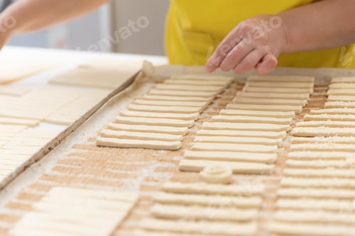 Preview: Thinly rolled and cut into strips of dough for crackers.