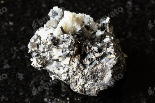 Preview: sample of raw arsenopyrite rock on black granite