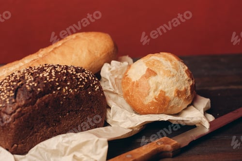Preview: flour products rye bread on packaging and wooden table knife red background