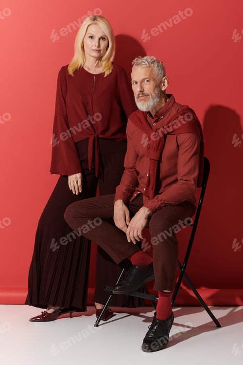 Preview: Senior couple showcases timeless love and stylish elegance against a bold backdrop