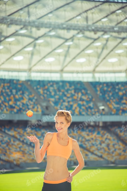 Preview: Sport Girl Holding A Green Apple.