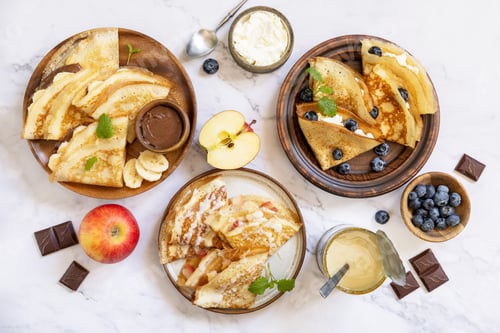 Preview: Celebrating Pancake day, healthy breakfast. Homemade sweet crepes with blueberries, ricotta, apples,