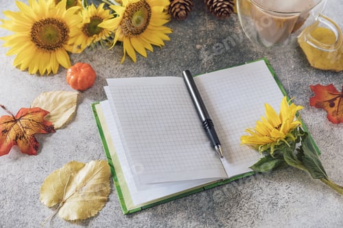 Preview: Good Morning. To do list concept. A bouquet of large sunflowers, coffee cup and empty notebook.