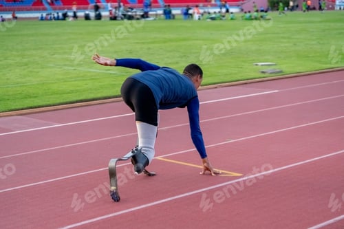 Preview: Asian para-athletes with prosthetic blades sprint on a running track at stadium.