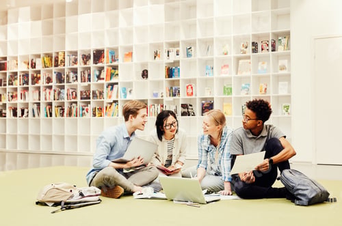Preview: Interracial students discussing ideas in library