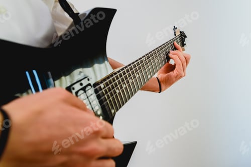 Preview: Close-up of the hands of a guitarist performing a song while pressing the strings.