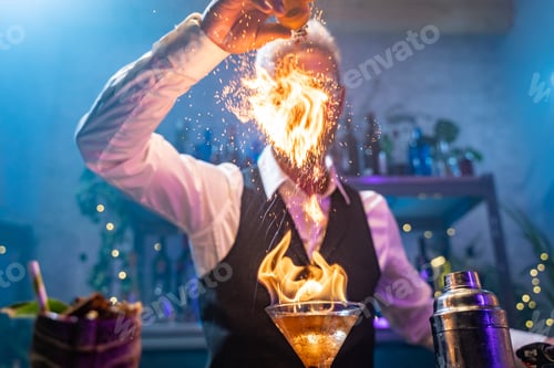 Preview: Bartender making a fire flame cocktail in a elegant night club party unique experience.