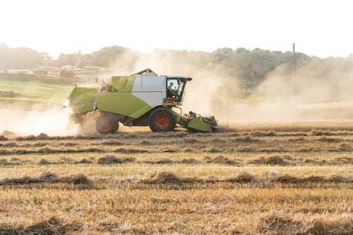Preview: Combine harvester working in wheat field on sunny day
