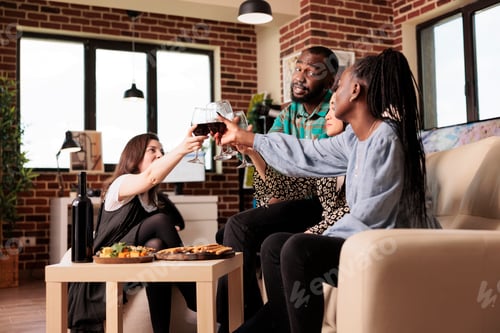 Preview: African american man toasting with female mixed ethnicity friends