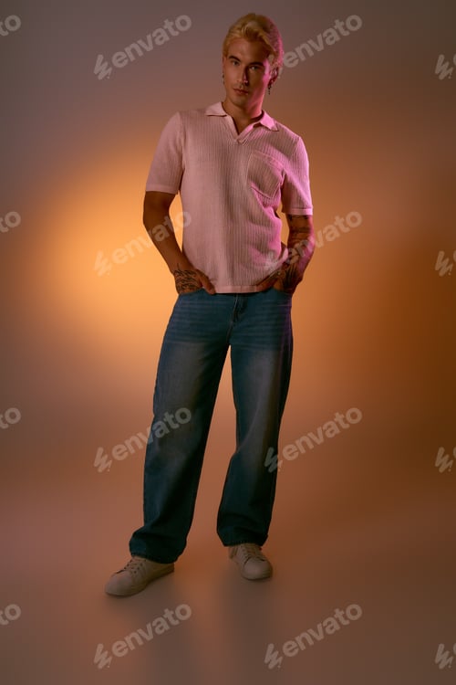 Preview: Stylish young man exudes charm with a modern look in a warm setting