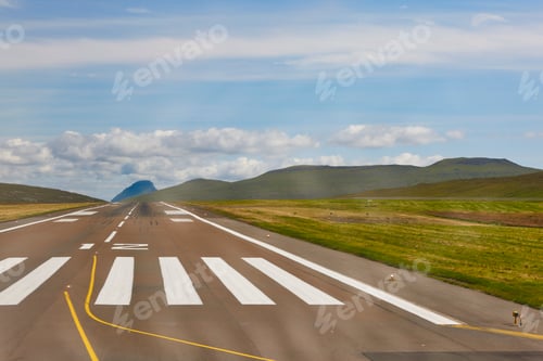 Preview: Airport runway surrounded by mountains in Faroe Islands. Denmark