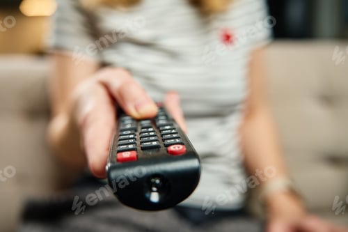 Preview: Woman holds TV remote control and switch channels