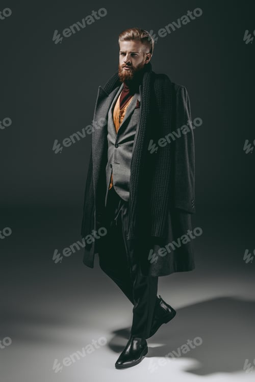 Preview: confident handsome bearded man posing isolated on black