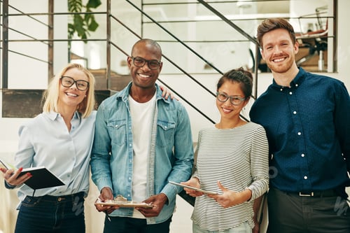 Preview: Diverse businesspeople laughing while working together in an office