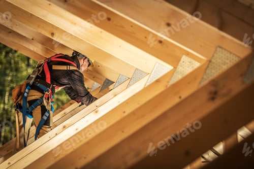 Preview: Worker Ascends Wooden Beams While Constructing a Roof in a Wooded Area