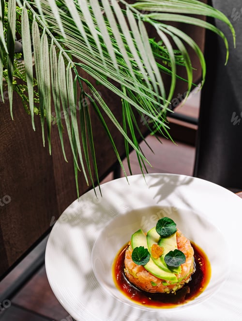 Preview: Fresh seafood dish served on a white plate with garnish and greenery